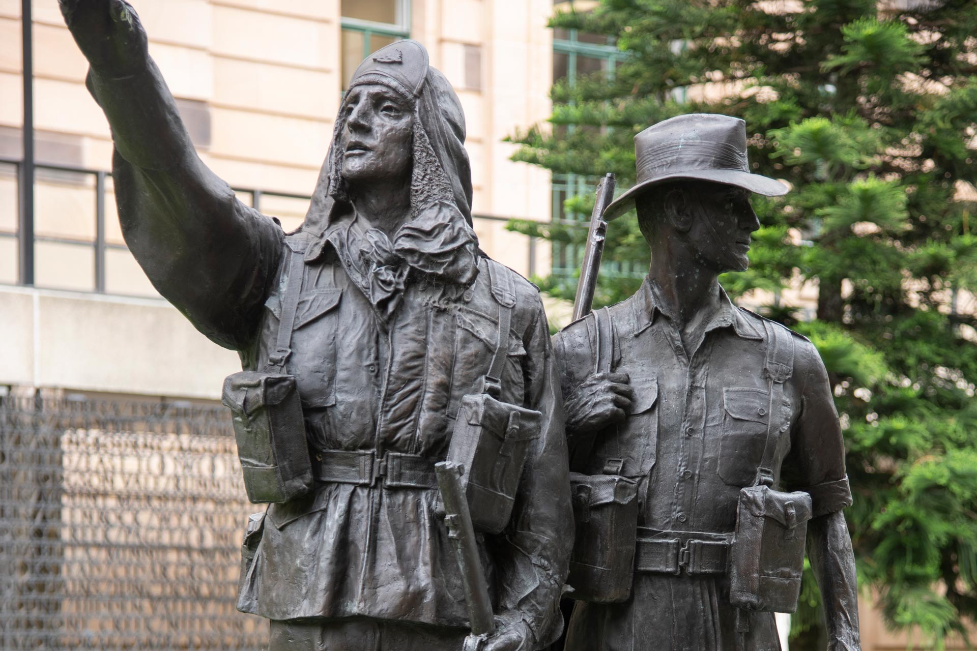 Statue of soldiers in winter and summer jungle uniforms.