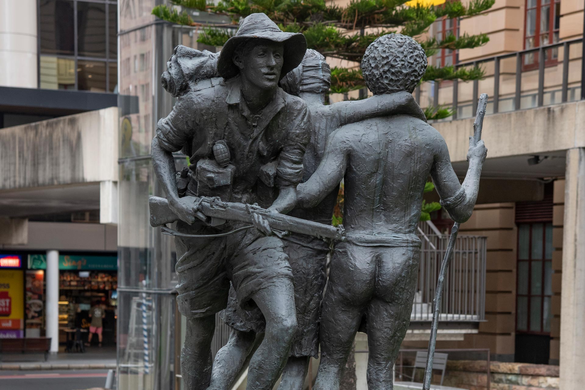 Statue of an Australian soldier being guided by a Papua New Guinean.