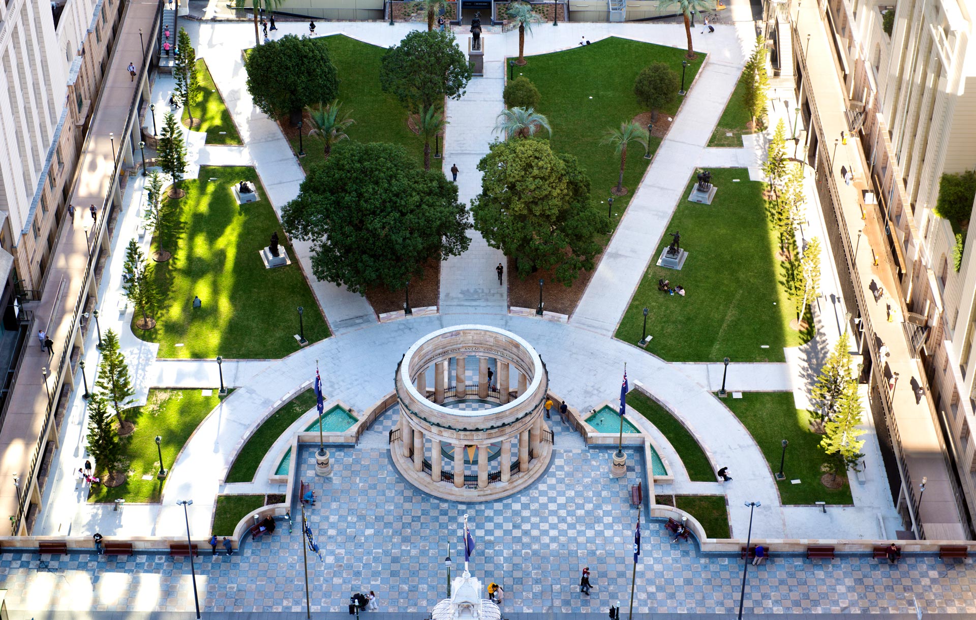 Aerial view of the Anzac Square parklands with the Shrine of Remembrance in the center and tall buildings around the outside.