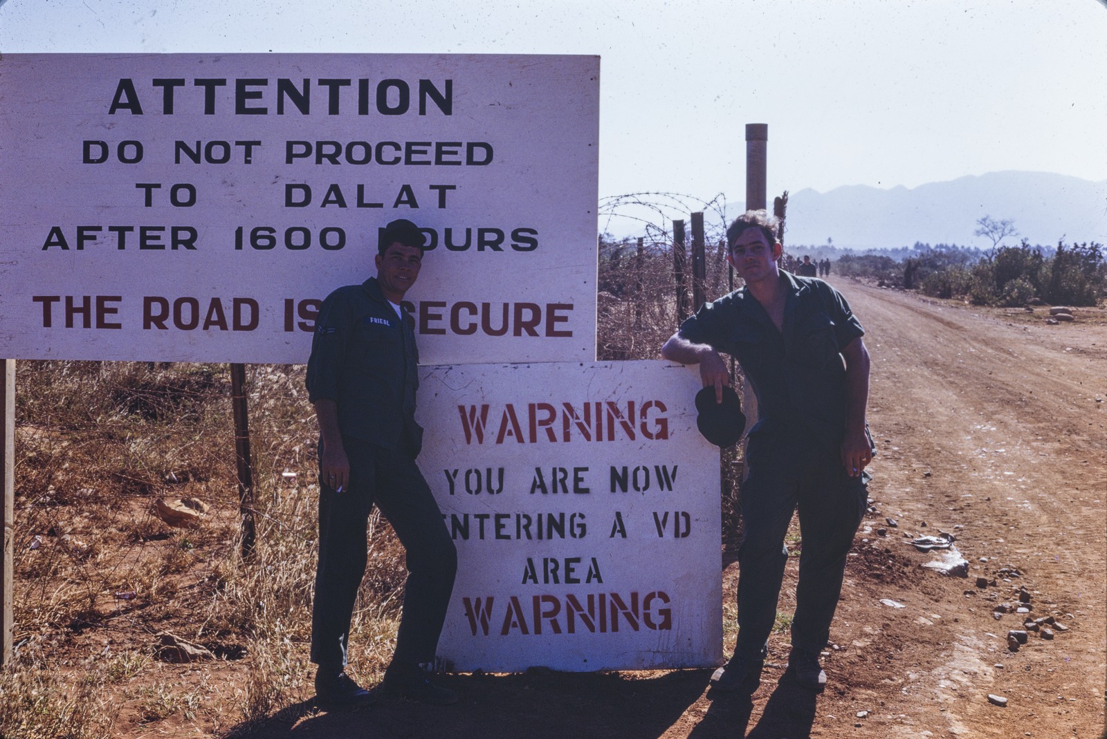Two Australian servicemen on the road to Dalat, just outside the perimeter of the RAAF base near Phan Rang, Vietnam, 1968-1969.