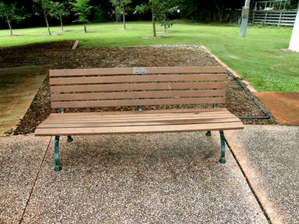 Wooden Park Bench in front of War Memorial