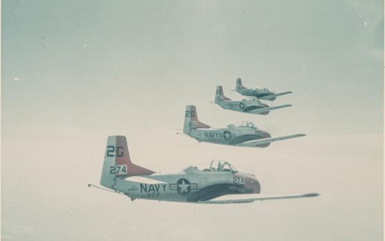 Four Navy aeroplanes in flight.