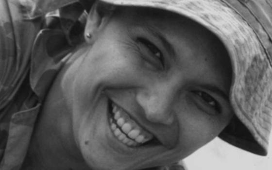 Close up photograph of Lorraine Hatton smiling and wearing a bucket hat.