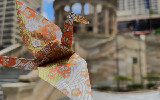 Paper crane flying over Anzac Square