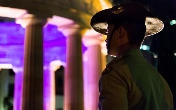 Young soldier standing at attention during the Anzac Day dawn service in Brisbane, Queensland