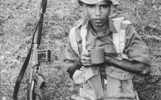 Claude Malone resting while on patrol, Vietnam War