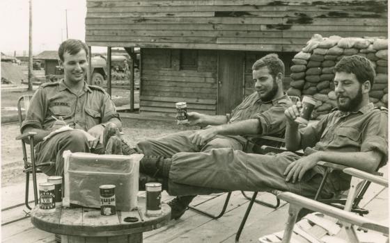 Captain Andrew Craig RAN photograph of three servicemen sitting around