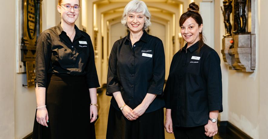 Photograph of three staff members smiling at the camera.