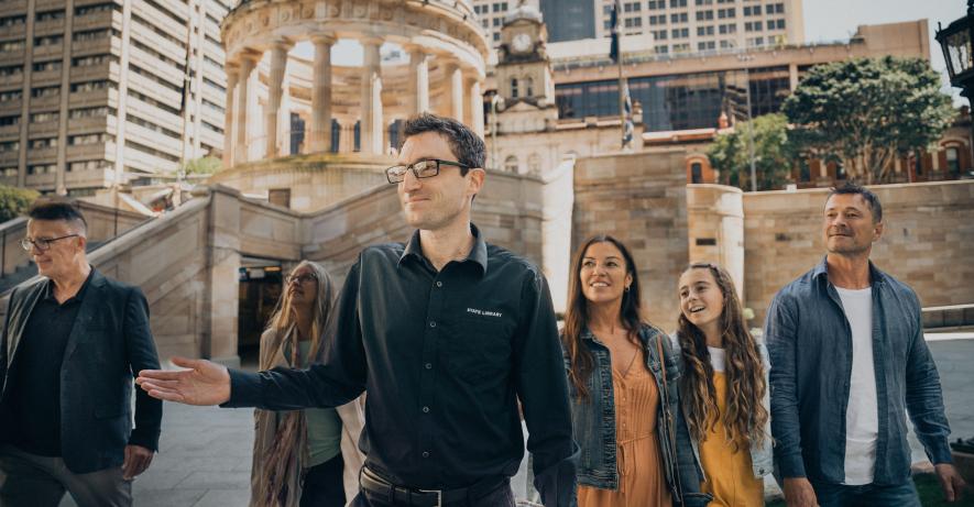 A guide taking visitors on tour of the Anzac Square Parklands