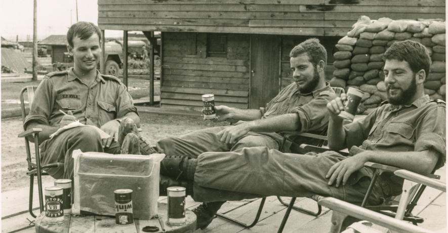 Captain Andrew Craig RAN photograph of three servicemen sitting around
